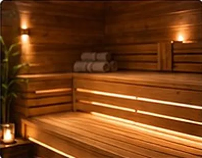 Warm-lit slatted sauna benches.